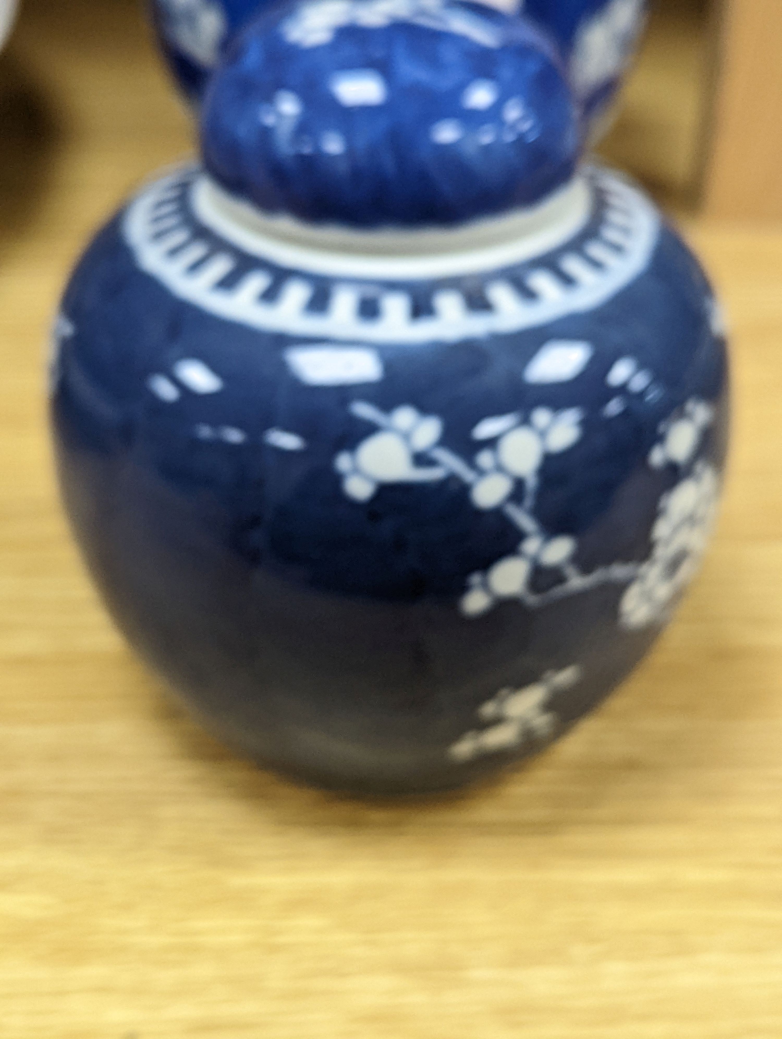 Three Chinese blue and white prunus decorated jars and covers, 19th/20th century, with four character marks 18cm